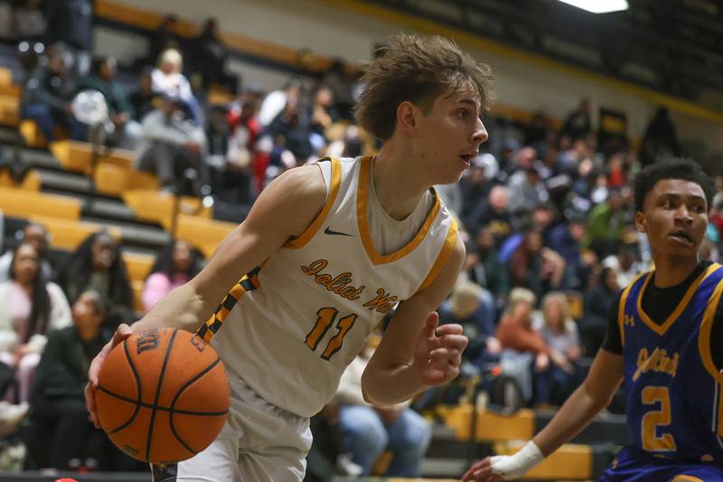 Joliet West’s Luke Grevengoed drives along the baseline against Joliet Central on Tuesday, Feb. 17, 2026 in Joliet.