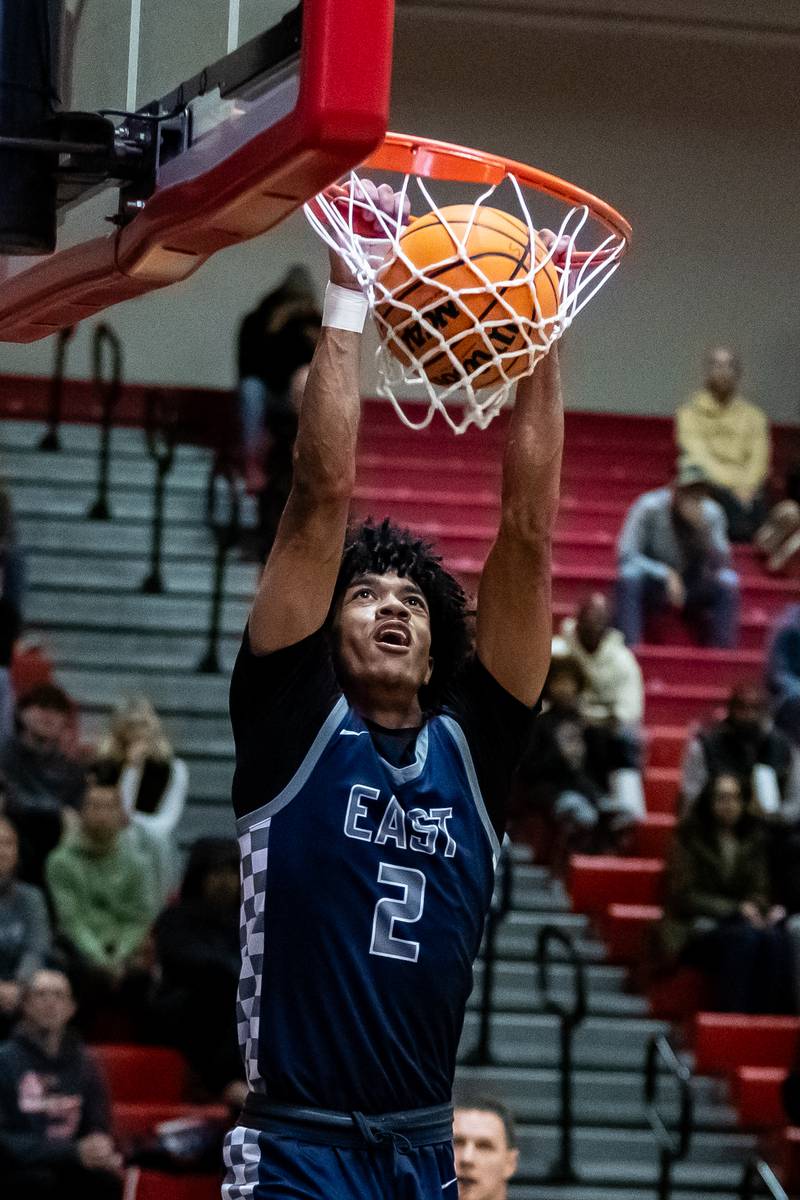Oswego East's Jacsen Tucker dunks during a varsity boys basketball game against Bolingbrook at Bolingbrook on Dec. 12, 2025.