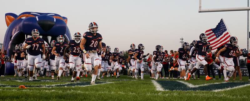 Oswego takes the field prior to kick-off against West Aurora during a football game at Oswego High School on Friday, Sept. 29, 2023.