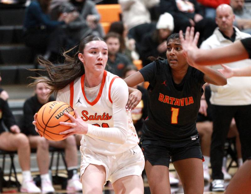St. Charles East’s Sofia O’Sullivan drives past Batavia’s Julia Arulandu during a game on Wednesday, Jan. 8, 2025 in St. Charles.