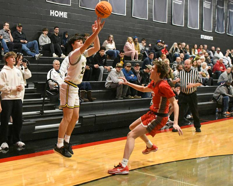 Yorkville Christian's Zach Marini, left, makes a three-point basket while being defended by Aurora Christian's Joe DeCort (4) during the game on Friday Feb. 28, 2025, held at Indian Creek High School.