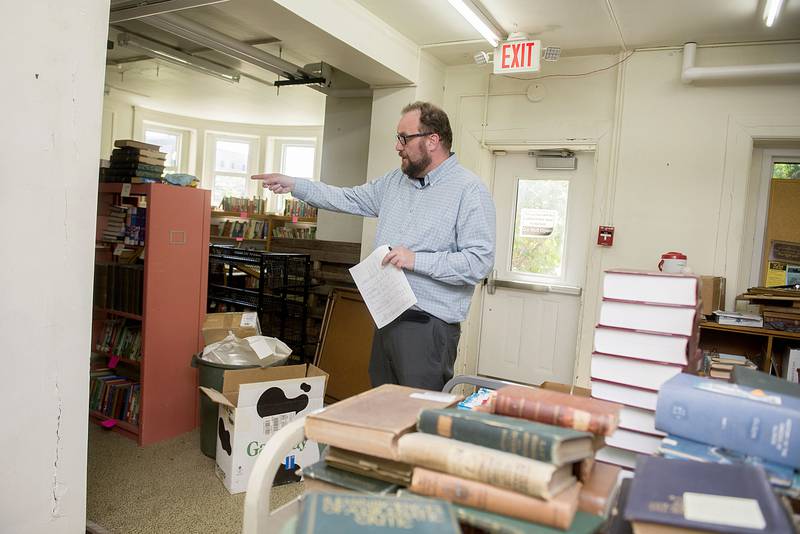 Dixon library director Antony Deter points out a section of the library that is poised to be renovated with a $210,000 federal grant. The grant will cover about a third of the planned fixes with another third coming from a state grant.