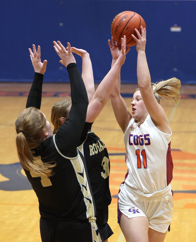 Genoa-Kingston's Emily Trzynka passes over two Rockford Christian defenders during their game Friday, Jan. 13, 2023, at Genoa-Kingston High School.