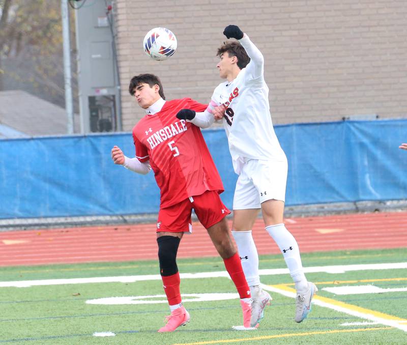 Hinsdale Central's Michael DiTomasso beats out Edwardsville's Henry Vivian to a header during the Class 3A State third place game on Saturday, Nov. 9, 2024 at Hoffman Estates High School.