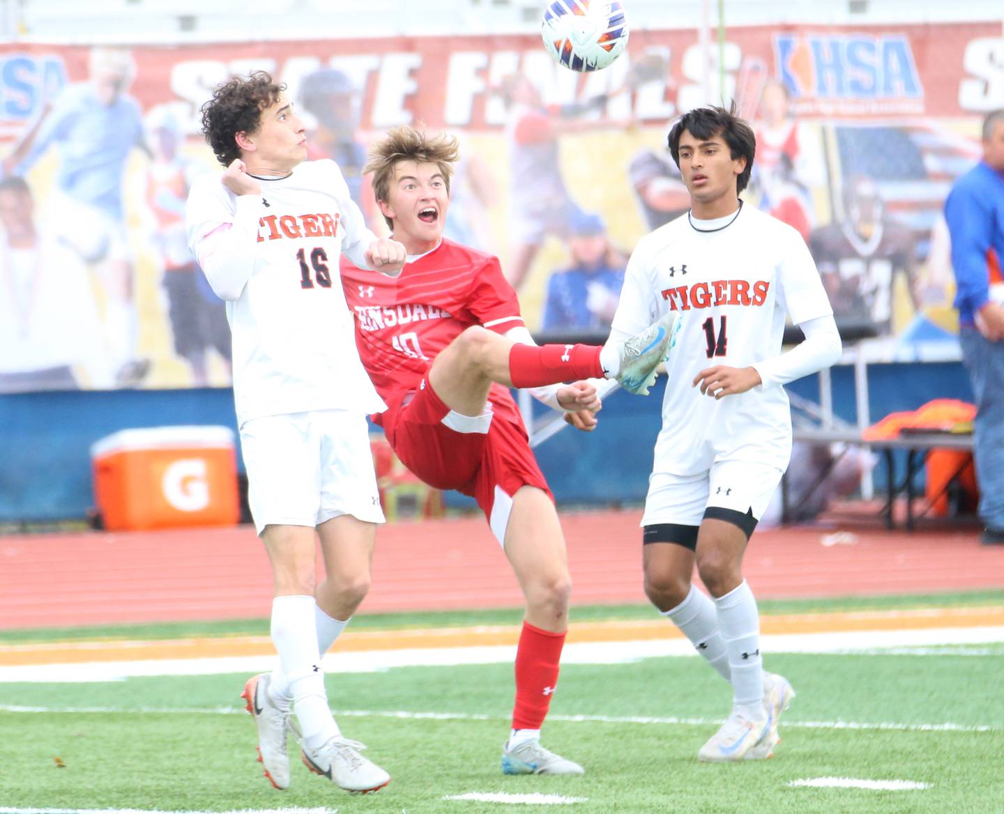 Hinsdale Central's Matt Gantar gets in between Edwardsville defenders Ben Leardi and Kaveen Shrestha to come up with the ball during the Class 3A State third place game on Saturday, Nov. 9, 2024 at Hoffman Estates High School.