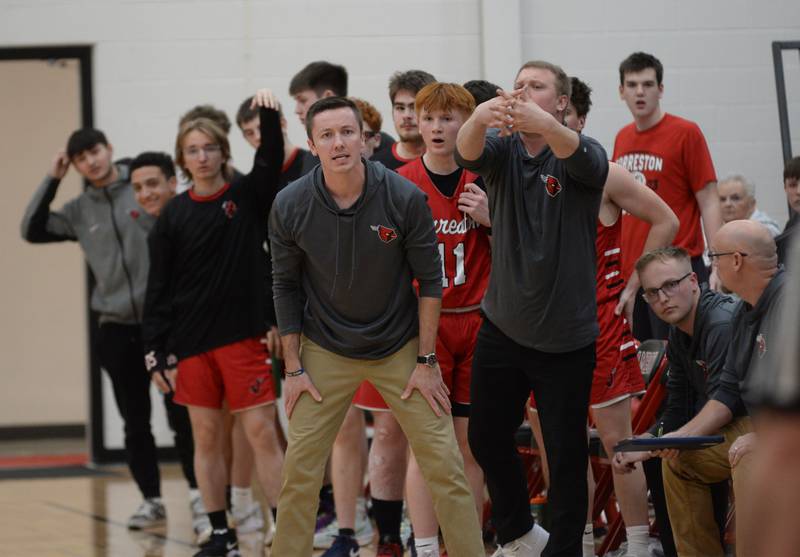 Forreston head coach Jake Groom (left) and assistant coach Robert DeVries and the Cardinals' bench react to a call during action against Annawan at the championship of the 1A Amboy Regional on Friday, Feb. 28, 2025 at Amboy High School.