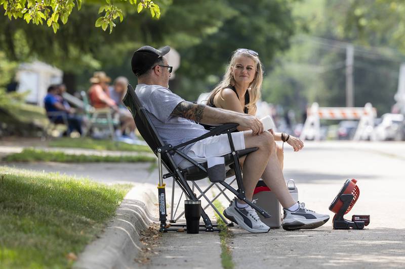 Tommy Raia of Ashton and Dagmara Sidorsky of Bartlett find shade Friday, July 4, 2025, at Petunia Fest’s car show.