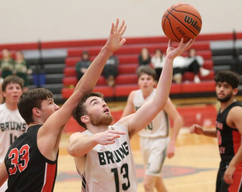 St. Bede's Mason Ross eyes the basket as Stillman Valley's Jacob Rhodes defends during the 49th annual Colmone Class on Thursday, Dec. 7, 2023 at Hall High School.