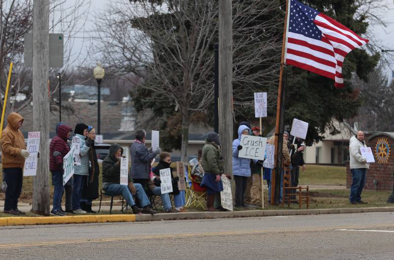 Protesters hold signs during a "ICE Out For Good" protest on Saturday, Jan. 10, 2026 at Rotary Park in Princeton. The Bureau County Democrats organized the event. About two-dozen protesters gathered to protest the ICE officer who shot and killed Renee Nicole Good in Minneapolis on Jan. 7.