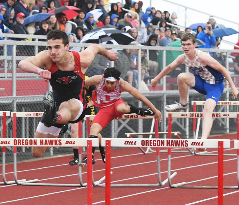 Forreston-Polo's Matthew Beltran clears a hurdle as he wins the 100 hurdles at the 1A Oregon Sectional on Friday. Behind Beltrran is Oregon's Kenrick Oriyavong who finished second.