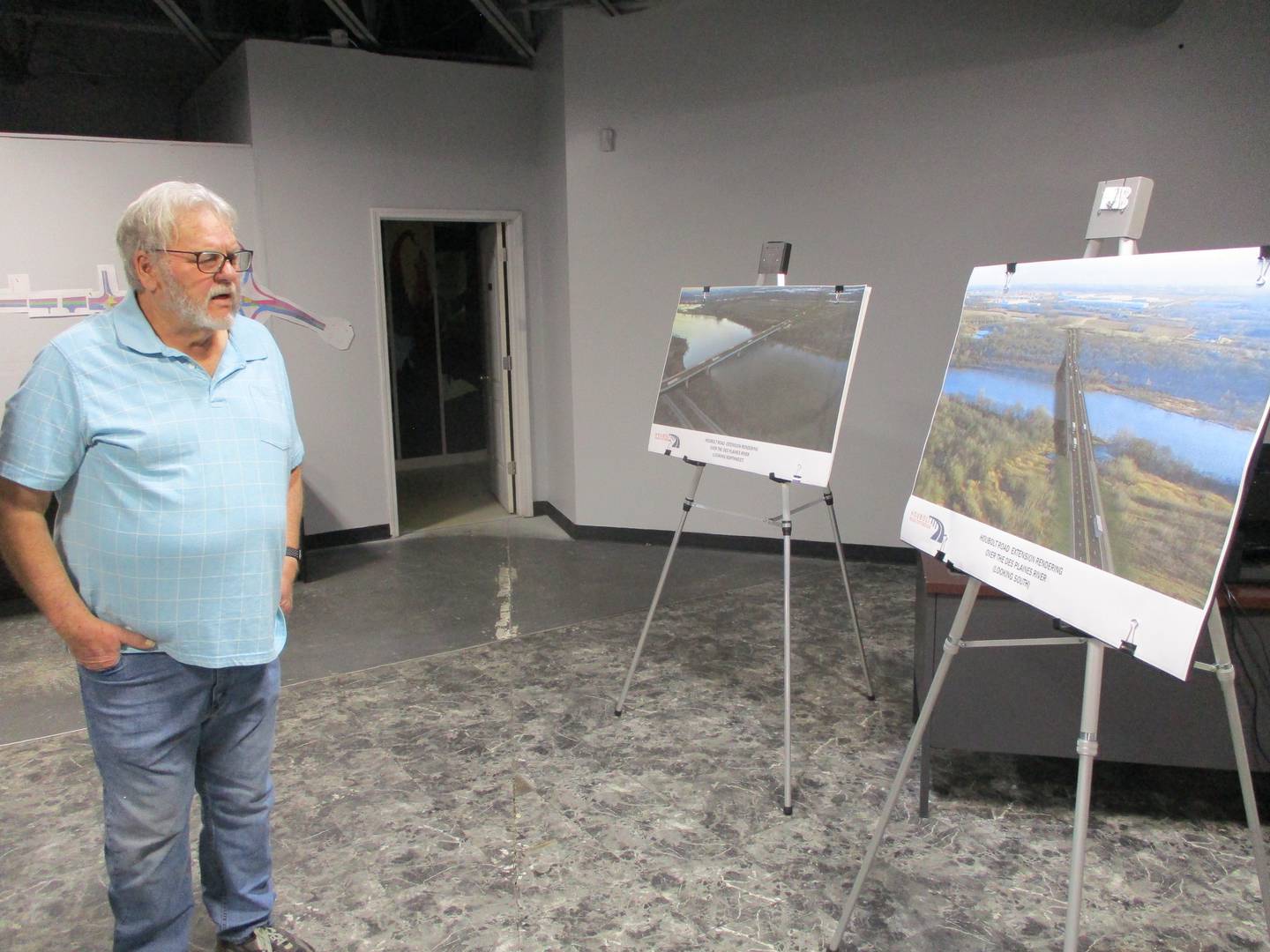 Chuck Link checks out a artist's rendering of the future Houbolt Road bridge during an informational meeting on the project on April 6, 2022 in Joliet.