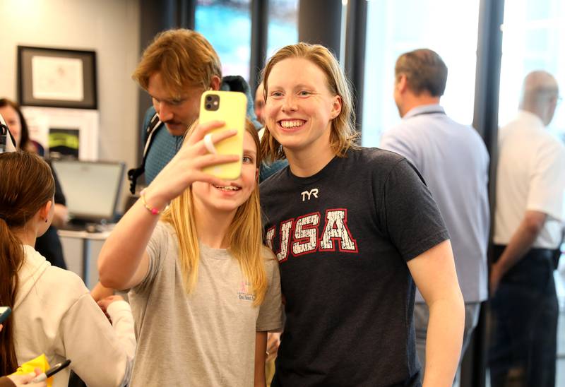 Olympic swimmer Lilly King (right) poses for photos during the Tyr Pro Swim Series Westmont at the FMC Natatorium in Westmont Thursday, March 3, 2022. The meet continues through Saturday.