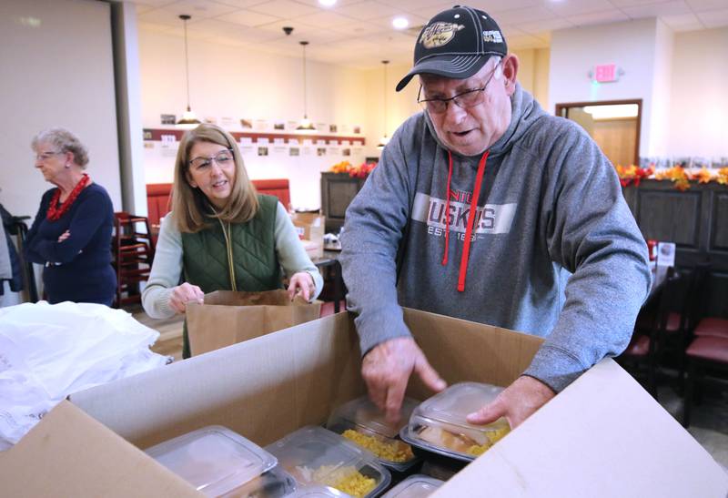 Volunteers Judy Carpenter and Rick Tonozzi pack meals Friday, Nov. 11, 2022, during a Veterans Day drive-thru dinner event hosted by the DeKalb and Sycamore Elks Clubs at the Lincoln Inn at Faranda's. All veterans received free meals during the event.