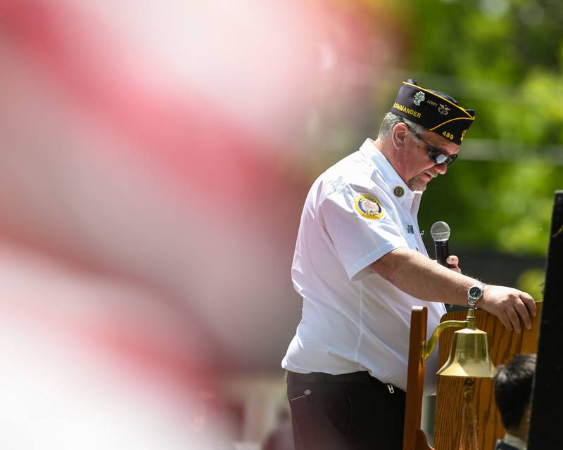 An American flag flaps in the wind as American Legion Commander Jeffrey Sanders speaks during the Memorial Day event on Monday May 26, 2025, held at Town Square Park in Yorkville.