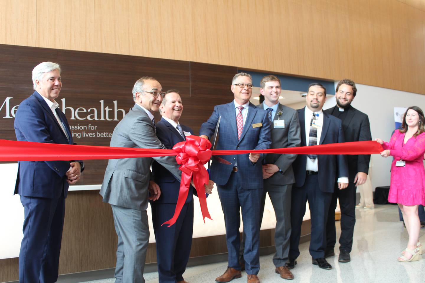 Jim McConaughey, Haig Haleblian, Javon Bea, Michael Buehler, Jacob Ginglen, Benjamin Danielson and John Kladar cut the ribbon at the Mercyhealth Crystal Lake Hospital ribbon cutting ceremony July 13, 2023.