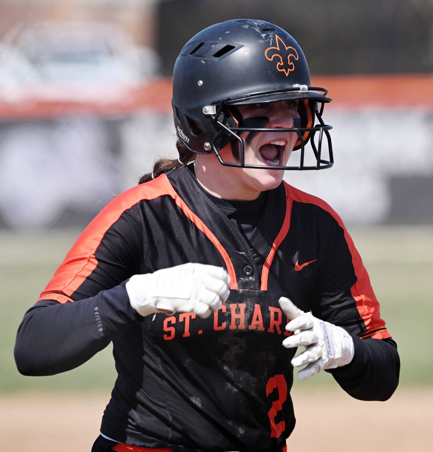 St. Charles East’s Addison Wolf looks toward her celebrating teammates as she arrives at home plate after hitting a leadoff home run against Huntley on Thursday, March 28, 2024 in St. Charles.