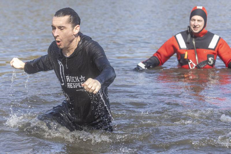 Jason Miller runs out of the frigid water of Lake Mendota during the Special Olympics Polar Plunge on February 24, 2024.