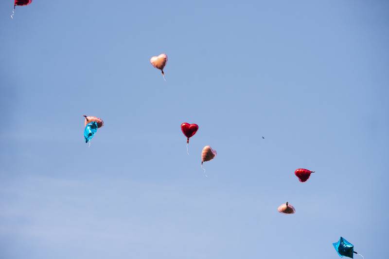 Balloons float overhead after being released in memory of Celina Serrano, 13, Shyla Walker, 8, and Carrie A. (Hall) Hose.