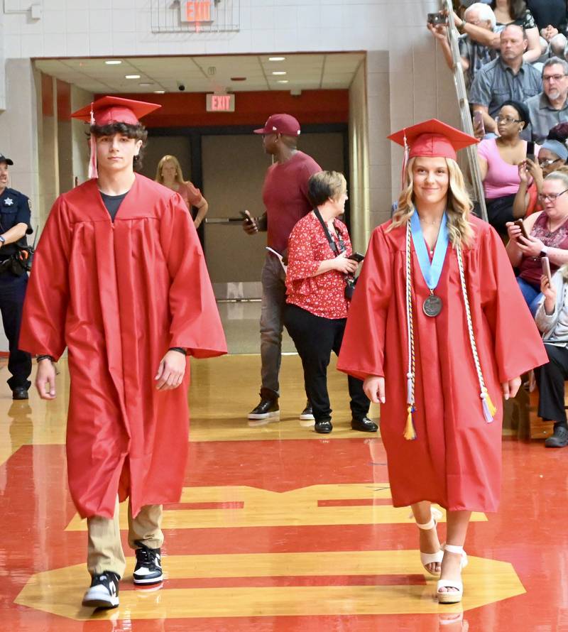 Landen Cook and Emma Devera walk during the Class of 2025 Commencement ceremony on Sunday, May 18, 2025 at Streator Township High School.