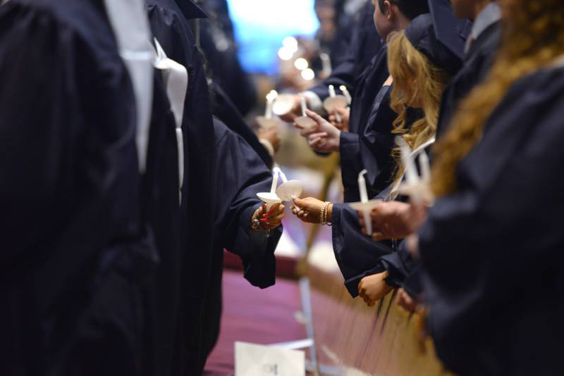 Nazareth graduates light candles during part of the mass and graduation celebration on Sunday, May 18, 2025 at Christ Church of Oak Brook.
