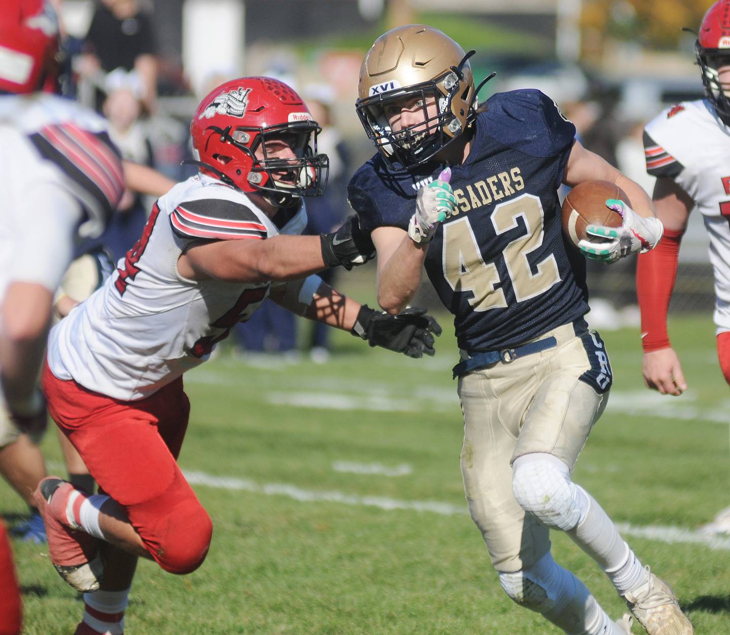 Marquette's Logan Nelson (42) avoids the tackle of Fulton's Joey Hulzenga at Gould Stadium on Saturday, Nov. 6, 2021.