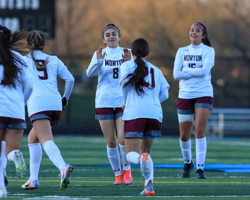 Morton's Leslie Jiminez (8) celebrates a goal by Carisma Rosales (21) during soccer match between Morton at Willowbrook. April 14, 2022.