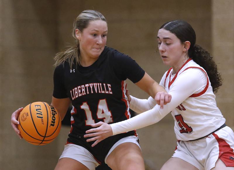 Libertyville's Sophia Cesnovar tries to drive the baseline against Huntley's Luca Garlin during the IHSA Class 4A Huntley Sectional Championship girls basketball game on Thursday, Feb. 27, 2025, at Huntley High School.
