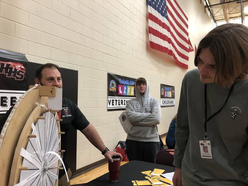 Huntley High School students spin the wheel during the school's Game of Life event Nov. 30, 2023.