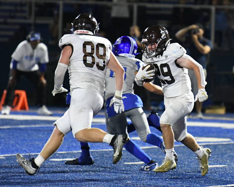 Joliet Catholic Academy’s Michael Jaworski, right, takes down St. Francis Ian Willis (2) in the second quarter on Friday Sep. 22, 2023, held at St. Francis High School in Wheaton.