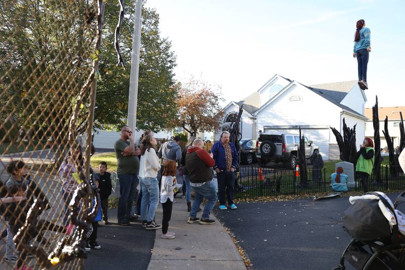 Visitors line up to take pictures at Dave Appel’s Plainfield home with a Halloween display based on the Netflix show "Stranger Things" and featuring a levitating Max character. Video of the display has gone viral on social media. Saturday, Oct. 8, 2022, in Plainfield.