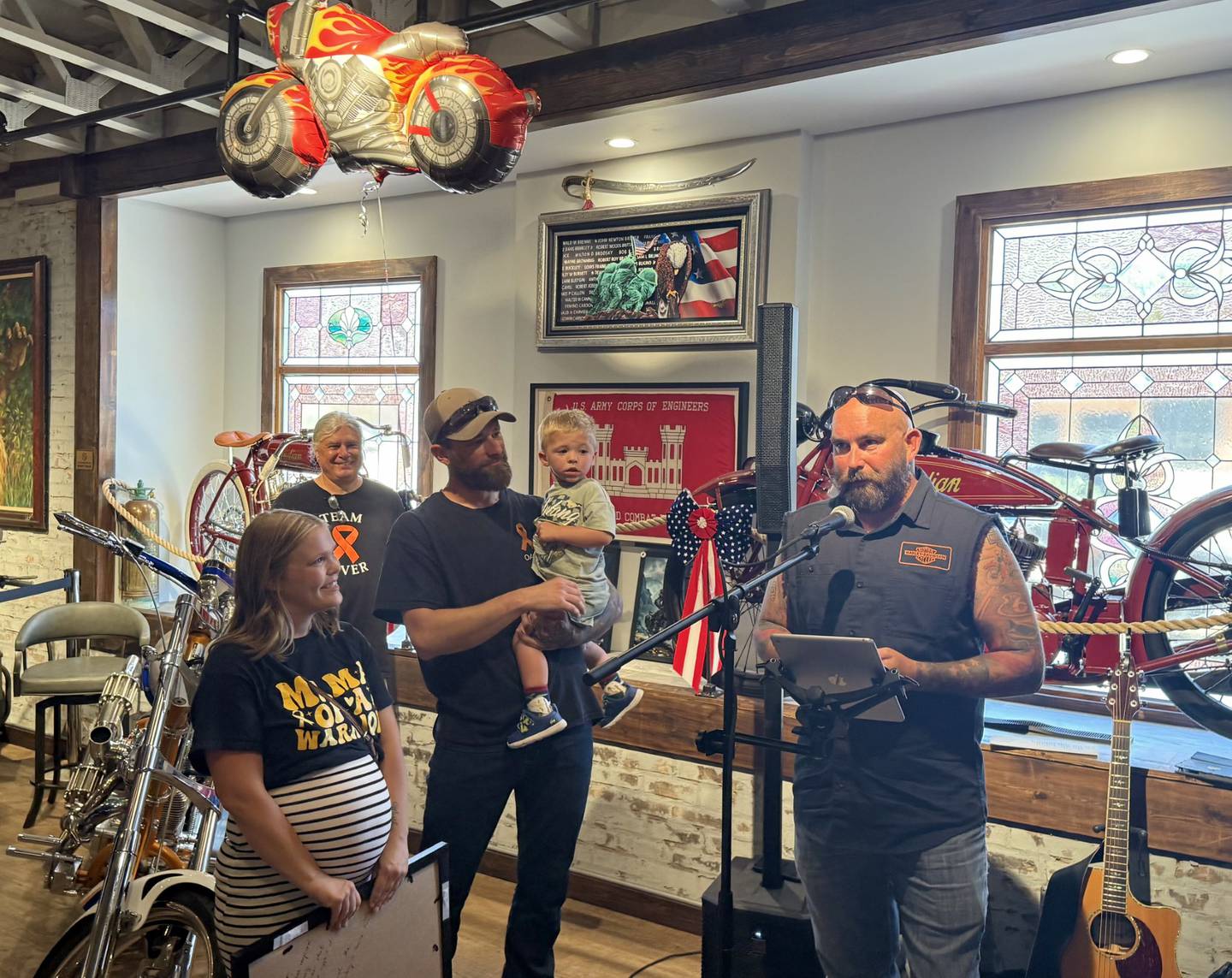 A.B.A.T.E. president Chris Hansen (right) thanks supporters after a motorcycle ride to support 2-year-old Oliver Olinger, alongside his parents, Nathan Olinger and Sami Olinger, at the St. Charles Motorcycle Museum, 1317 E. Main St. in St. Charles on Sunday, June 22, 2025.