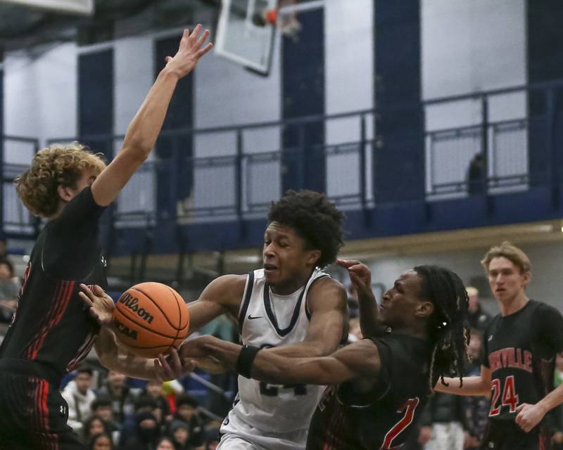Oswego East's Dshaun Bolden (24) is fouled under the basket during their basketball game between Yorkville at Oswego East. Friday, Dec 19, 2025 in Oswego.