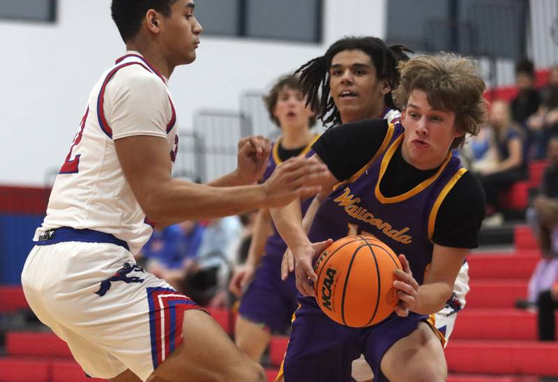 Dundee-Crown’s Anthony Jobe, left, guards Wauconda’s Cole Plucinski in varsity basketball Friday, Dec. 20, 2024 at Dundee-Crown High School in Carpentersville.