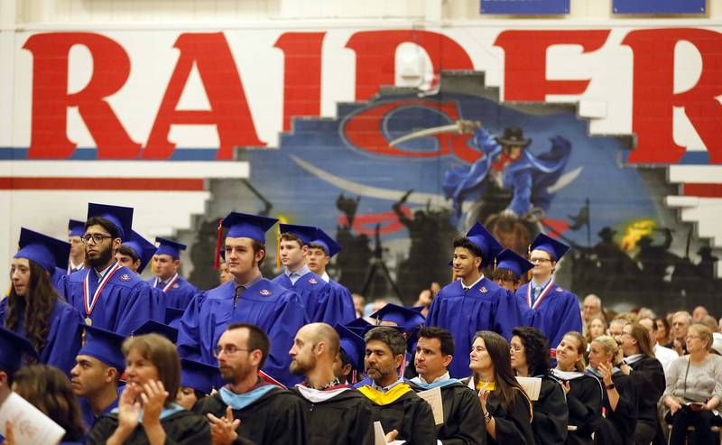Members of the National Honor Society stand and are recognized during the Glenbard South commencement ceremony Thursday May 18, 2023 in Glen Ellyn.