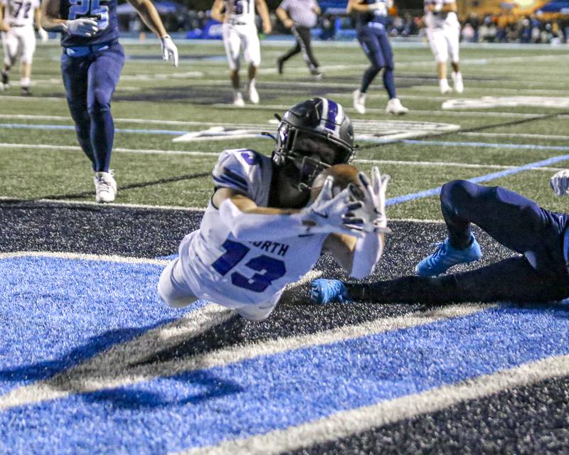 Downers Grove North's Joey Serpico (13) dives for a touchdown catch during football game between Downers Grove North at Downers Grove South Friday, Sept 5, 2025  in Downers Grove.