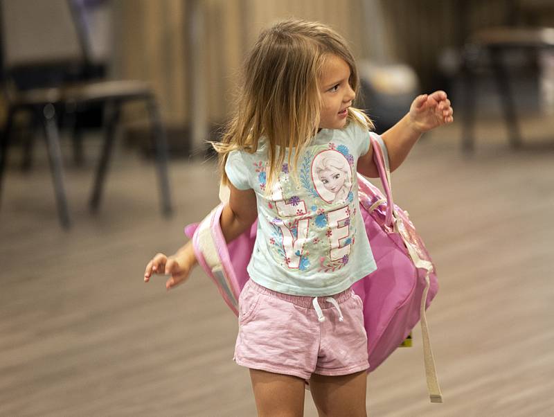 Sarah Callaway, 4, tries on her new backpack Thursday, Aug. 8, 2024, at the Tools for Schools distribution in Dixon.