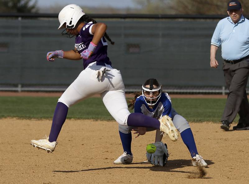 Hampshire's Julissa Akins avoided the ball as Burlington Central's Kelsey Covey tries to field the ground ball during a Fox Valley Conference  softball game on Tuesday, April 21, 2026, at Hampshire High School.