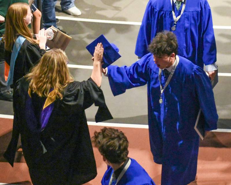 A St. Charles North Graduate gets a high-five during the graduation ceremony Monday, May 18, 2026, held at the NIU Convocation Center in DeKalb.
