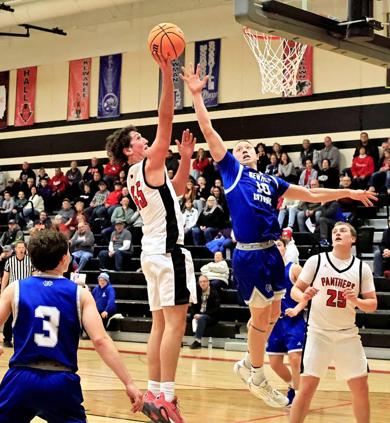 EP’s Gus Schultz goes above the attempted block of Newman’s George Jungerman for 2 points Wednesday, Jan. 28, 2026,  in a conference game between the EP Panthers and the Newman Catholic Comets. Despite their best efforts, the Panthers were unable to break the Comets undefeated winning streak this season. The Comets outscored the Panthers 57-49