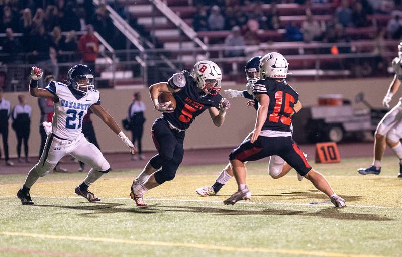 Benet Academy's Michael Lawler (5) carries the ball against Nazareth Academy during a football game at Benedictine University in Lisle on Friday, Oct 21, 2022.