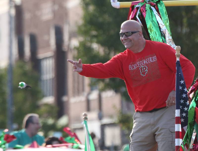 La Salle mayor Jeff Grove throws candy during the L-P Homecoming parade on Thursday, Oct. 5, 2023 downtown La Salle.