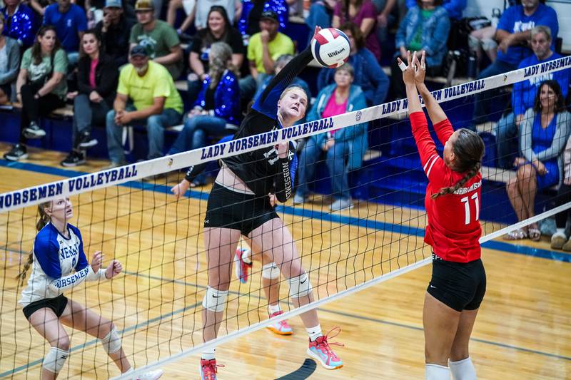 Newark’s Zoey Carlson (17) goes up for a kill against Aurora Christian's Gabriella Cotto (11) during a non-conference match at Newark High School on Tuesday, Sept. 9, 2025.