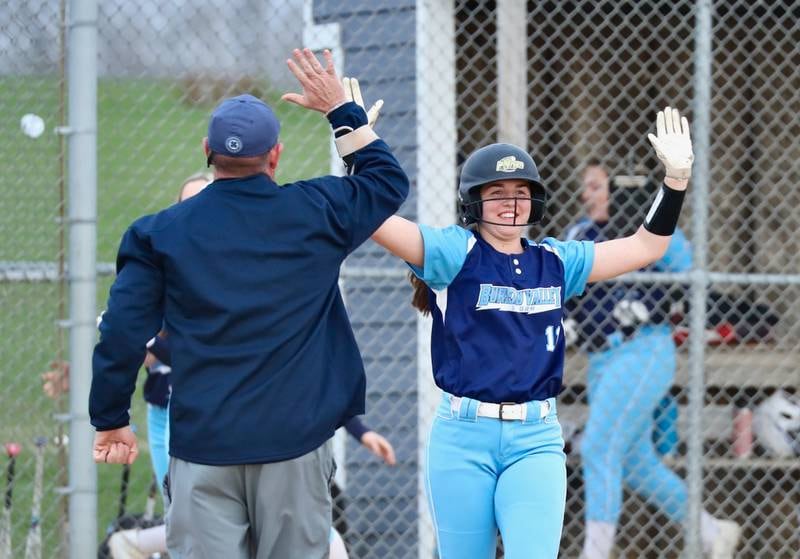 Bureau Valley's Madison Smith and assistant coach Chris Maynard celebrate the Storm's walk-off hit Thursday.