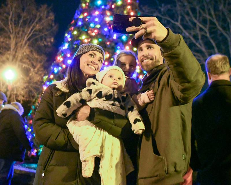 The Schick family of Yorkville Meagan, Sophie, 7-month, Grace, 5, and Ralph take a selfie in front of the lighted tree after the tree lighting ceremony on Friday Nov. 21, 2025, held at Riverfront Park in Yorkville.