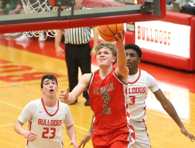 L-P's Braylin Bond drives to the hoop past Streator's Colin Byers and Sharonn Morton on Tuesday, Jan. 13, 2026 in Pops Dale Gymnasium at Streator High School.