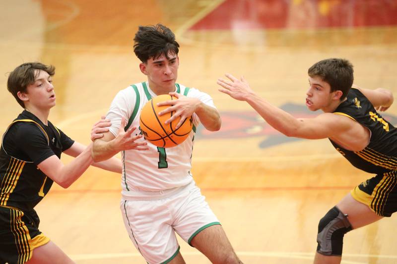 Rock Falls's Austin Castaneda eyes the hoop against Putnam County's AJ Furar during the 50th annual Colmone Classic on Monday, Dec. 9, 2024 at Hall High School.