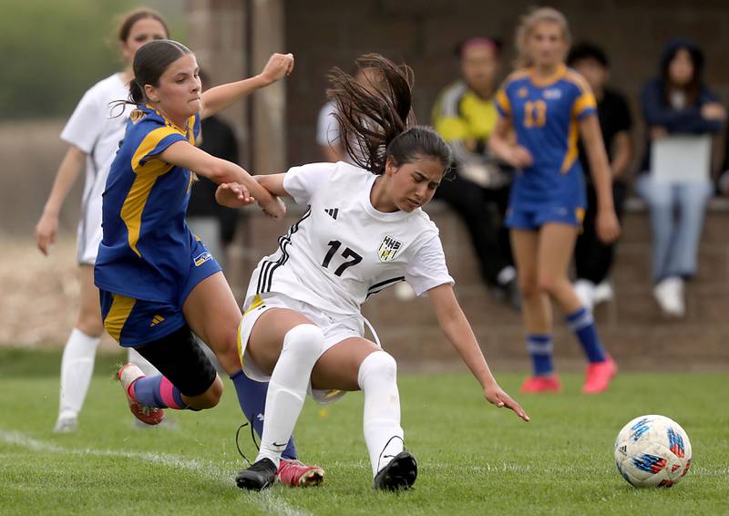 Johnsburg's Liz Smith pulls down Harvard's Aimar Citlali Nava during a Kishwaukee River Conference soccer match on Wednesday, April 27, 2026, at Johnsburg High School.