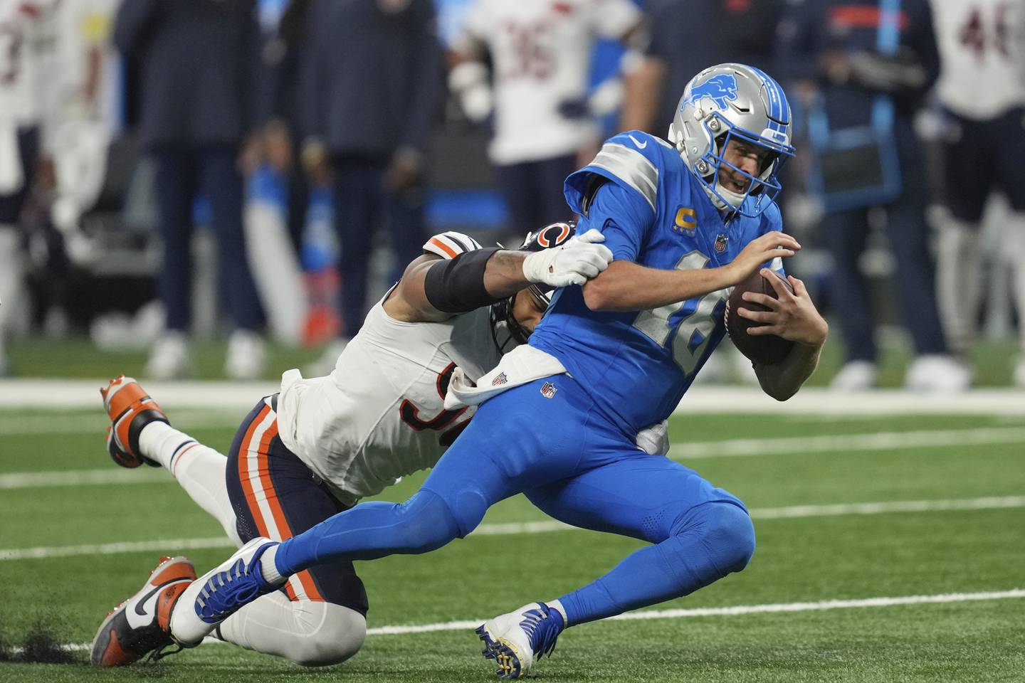 Detroit Lions quarterback Jared Goff (16) is hit by Chicago Bears defensive end Montez Sweat (98) on a run during the second half of an NFL football game in Detroit, Sunday, Sept. 14, 2025. (AP Photo/Paul Sancya)
