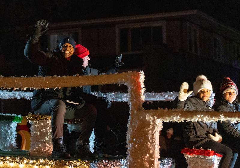 Parade Grand Marshal Jarrett Payton and his family head up the Holiday Homecoming Electric Christmas Parade in St. Charles on Saturday, Nov. 30, 2024.