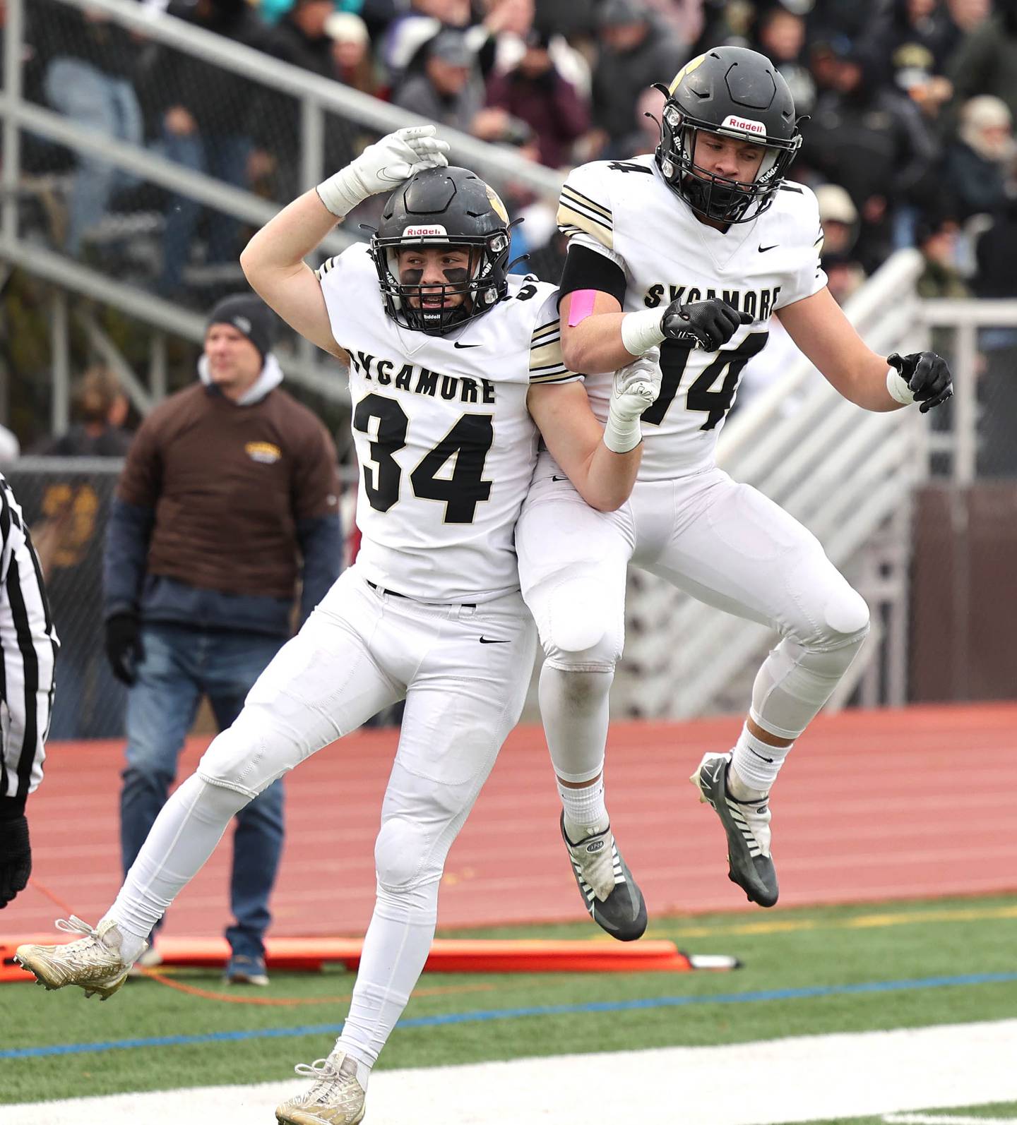 Sycamore's Joey Puleo (left) and Sycamore's Kiefer Tarnoki celebrate Puleo’s touchdown during their Class 5A second round playoff game against Carmel Saturday, Nov. 5, 2022, at Carmel Catholic High School in Mundelein.